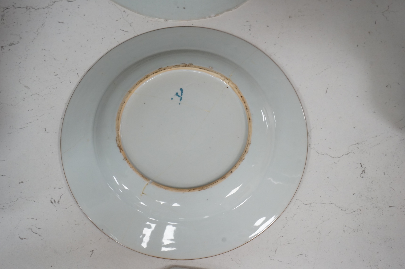 Three Chinese famille rose plates, Qianlong, including an armorial example, largest 22.5cm in diameter